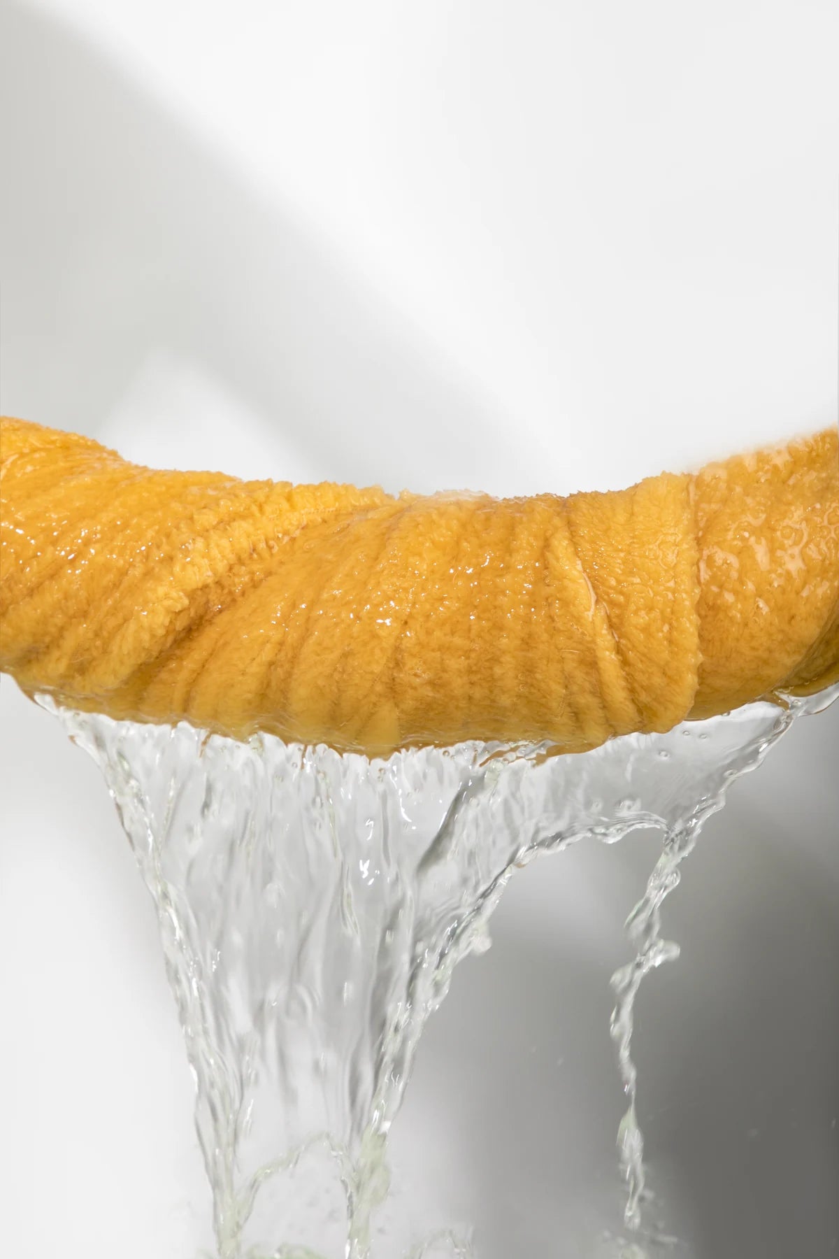 Water draining from the yellow towel in a source demonstration