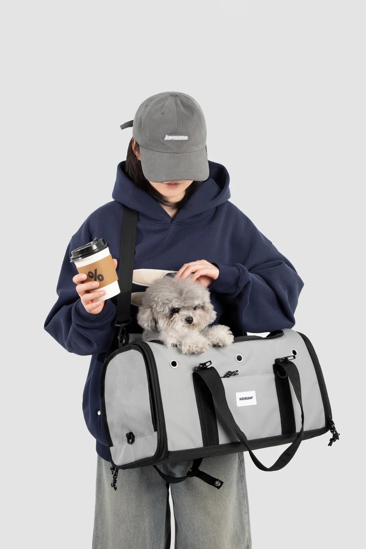 Owner holding the Cloud Gray carrier with a small dog