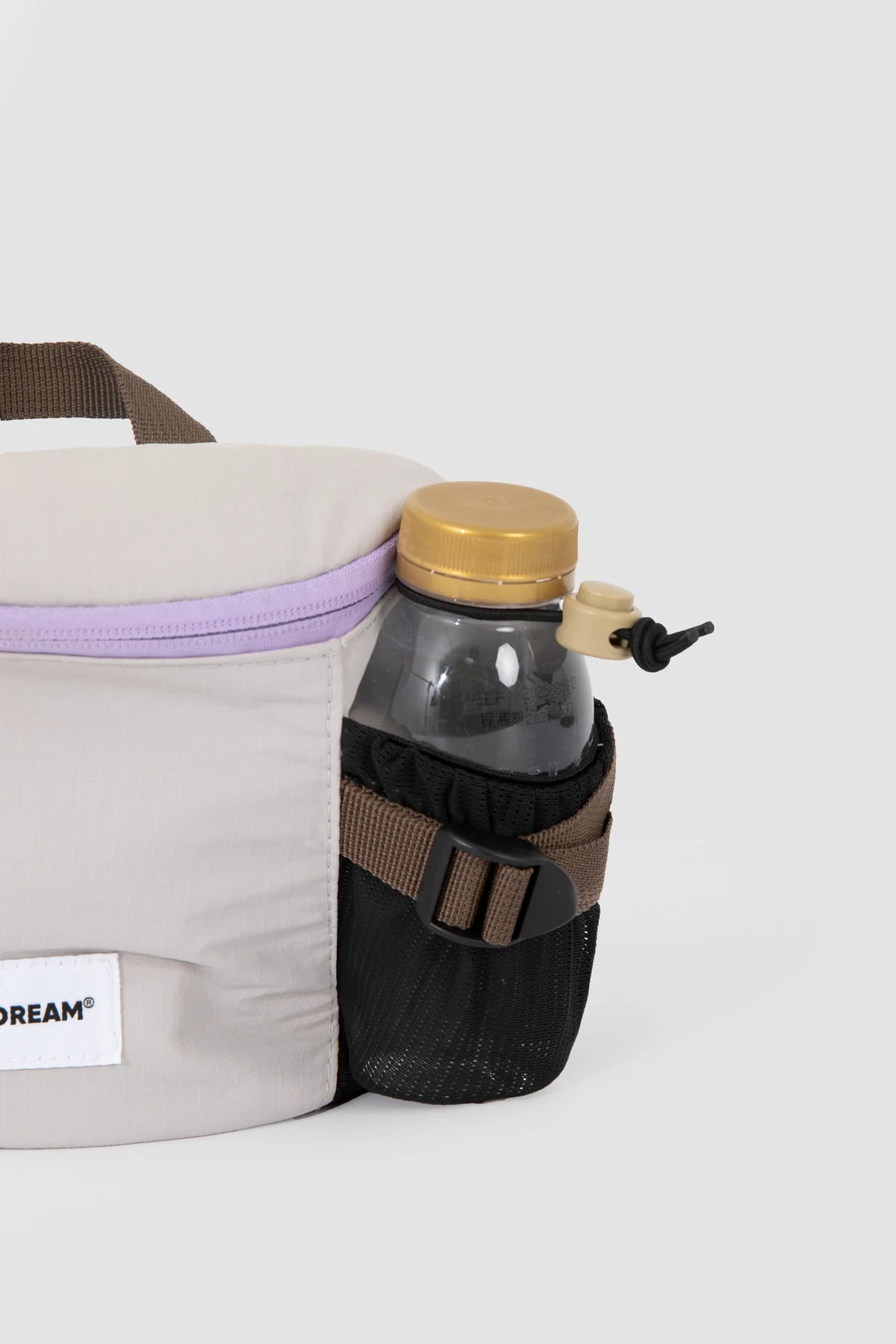 Integrated side bottle holder carrying an example bottle