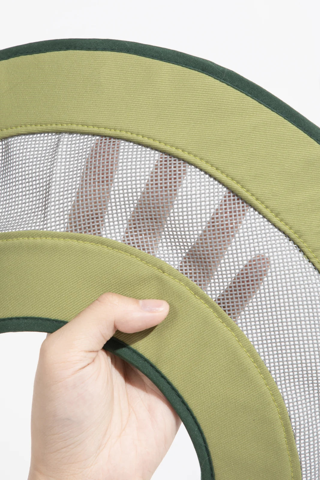Close-up of mesh panels and bound fabric edges