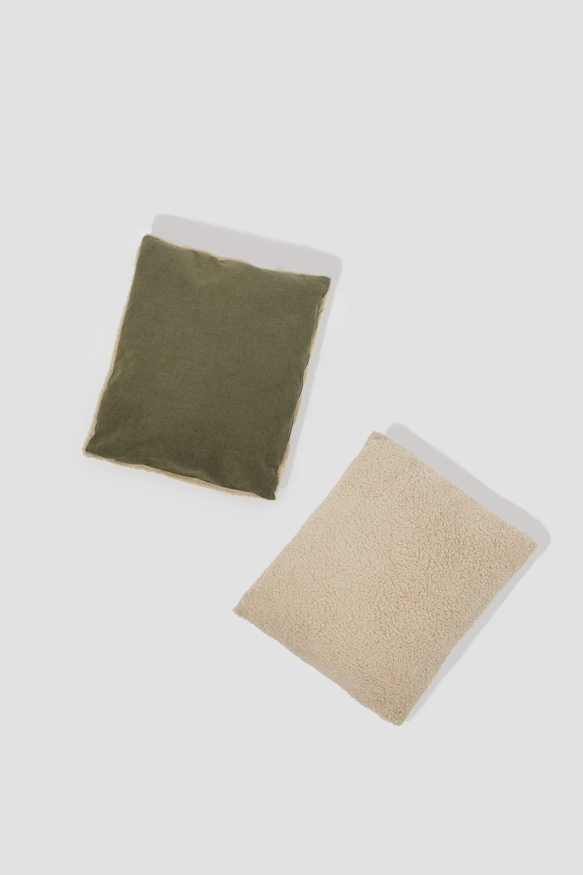 Both surfaces of the reversible cushion shown side by side