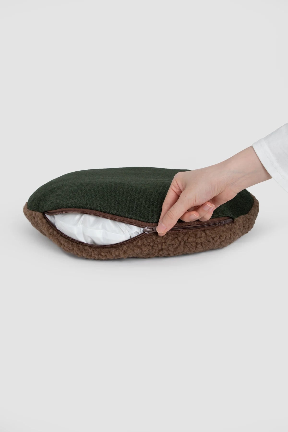 Hand opening the zipper on the removable Tart cushion