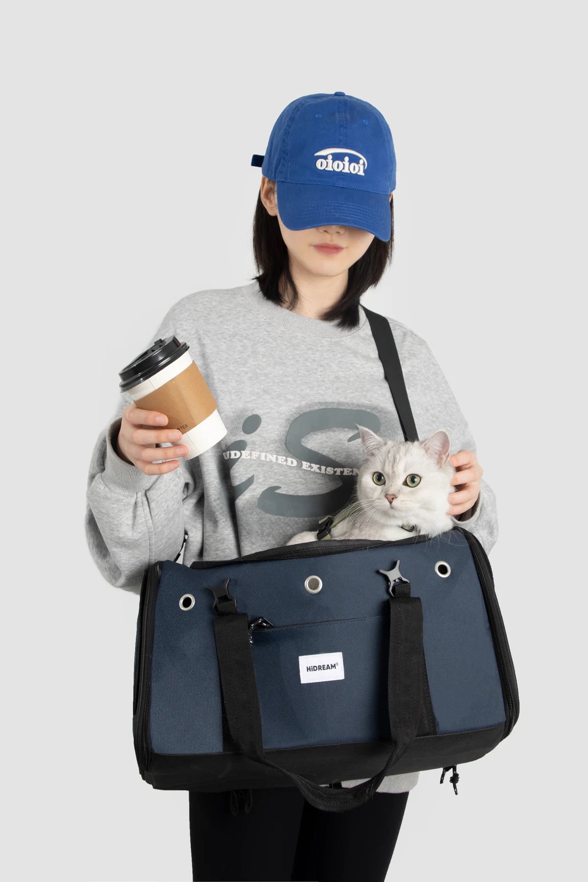 Owner holding the Denim Blue carrier with a dog