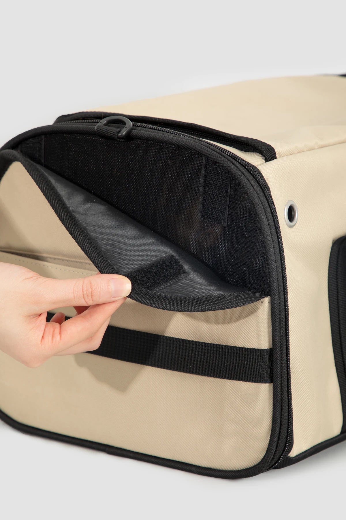 Hand opening the side mesh panel