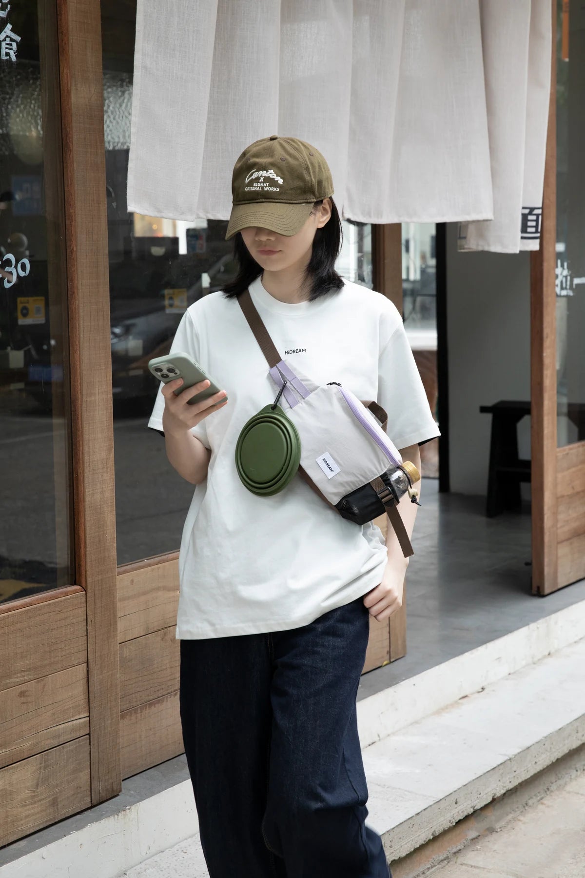 Gray walking pack worn crossbody outdoors; bowl shown separately