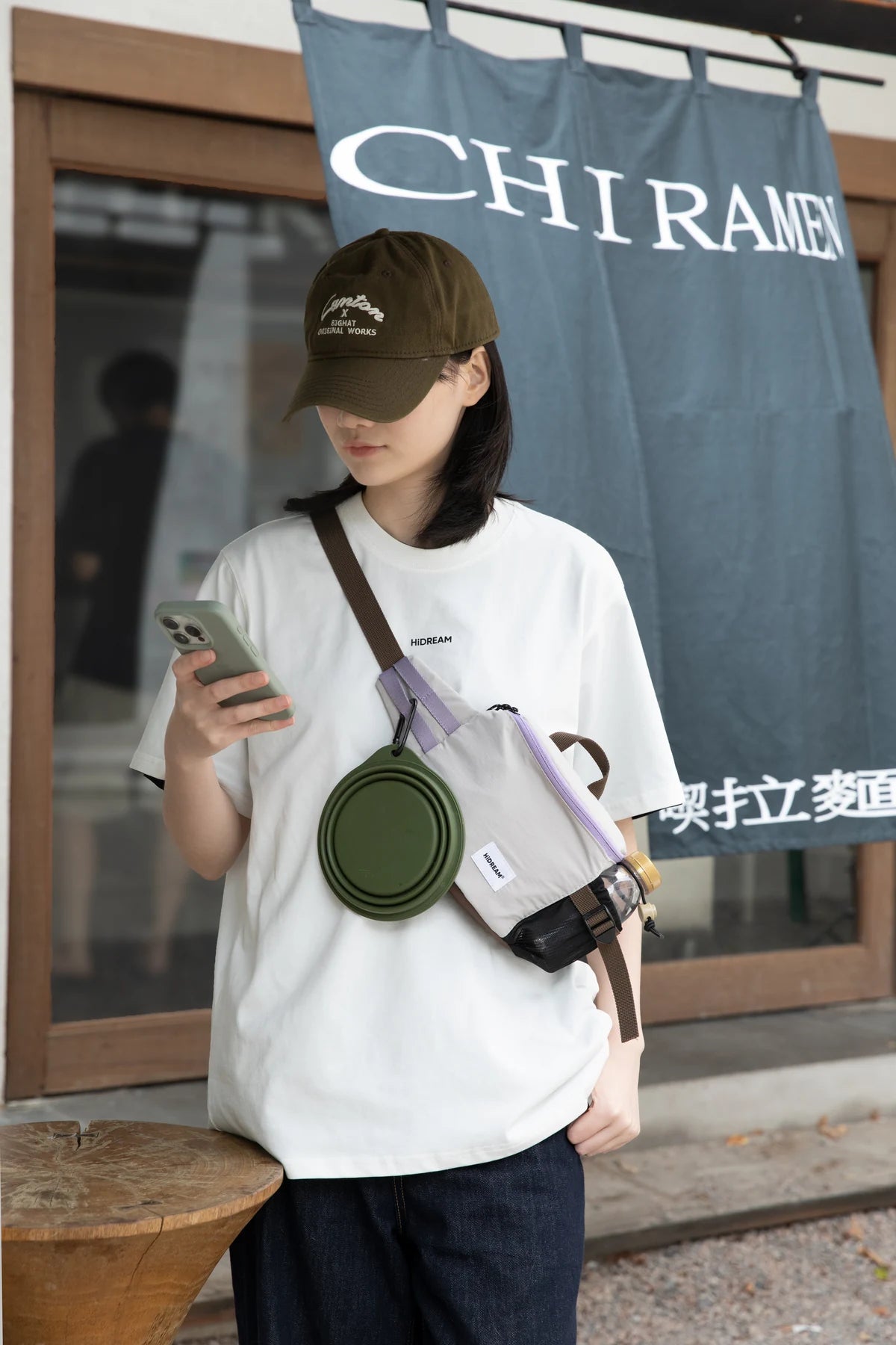 Owner outdoors with the Gray pack worn across the body