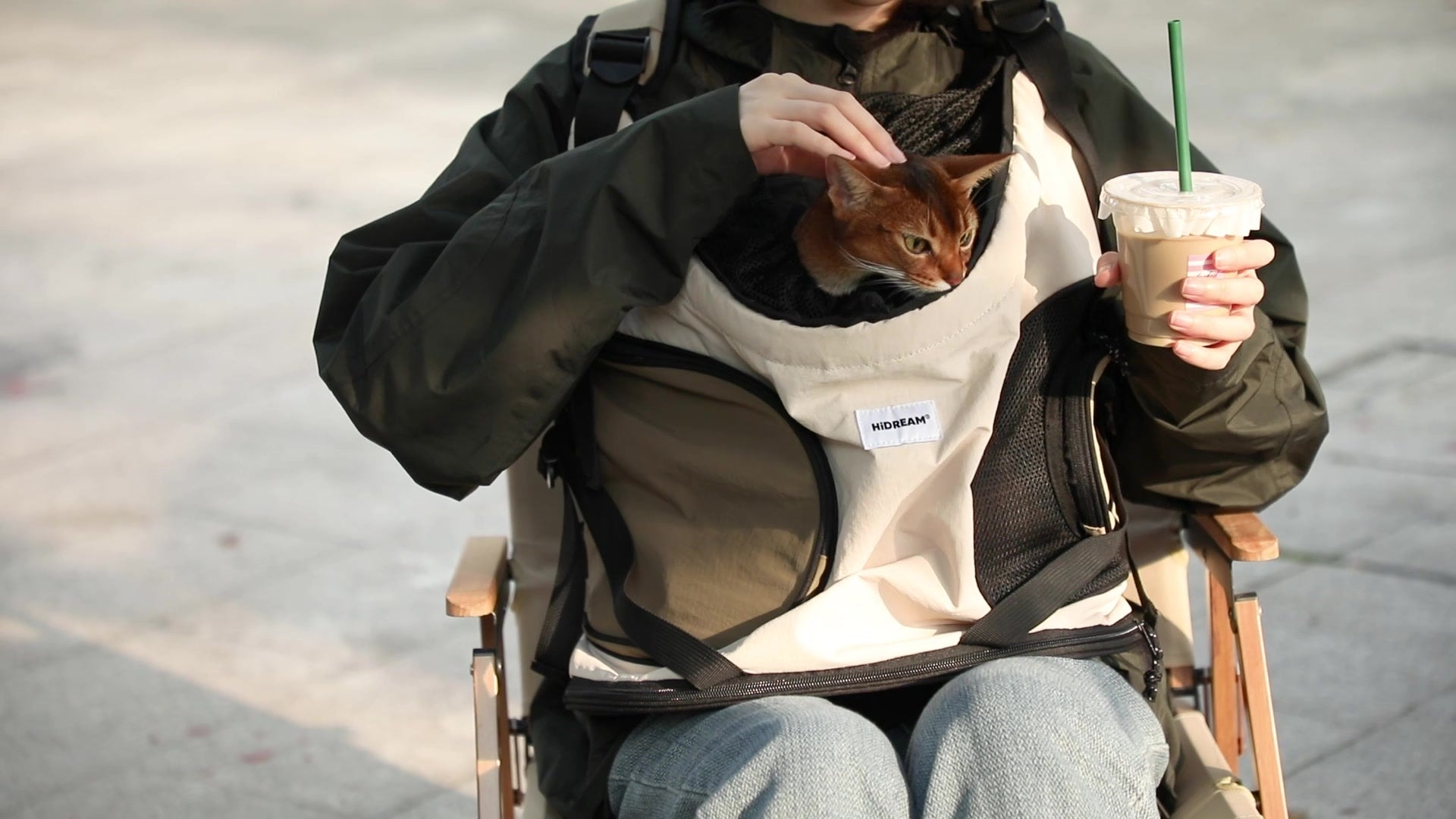 A quiet coffee break with a cat close by and a hand resting gently on its head