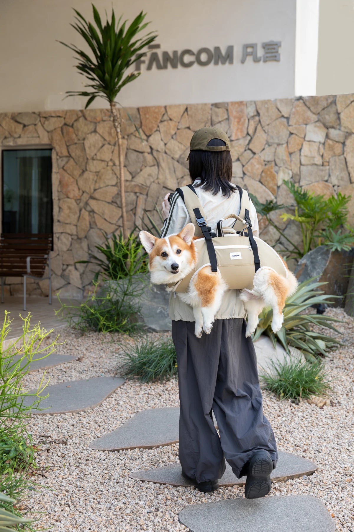 A dog joins their person for a pause outside in the Terracotta Brown horizontal carrier