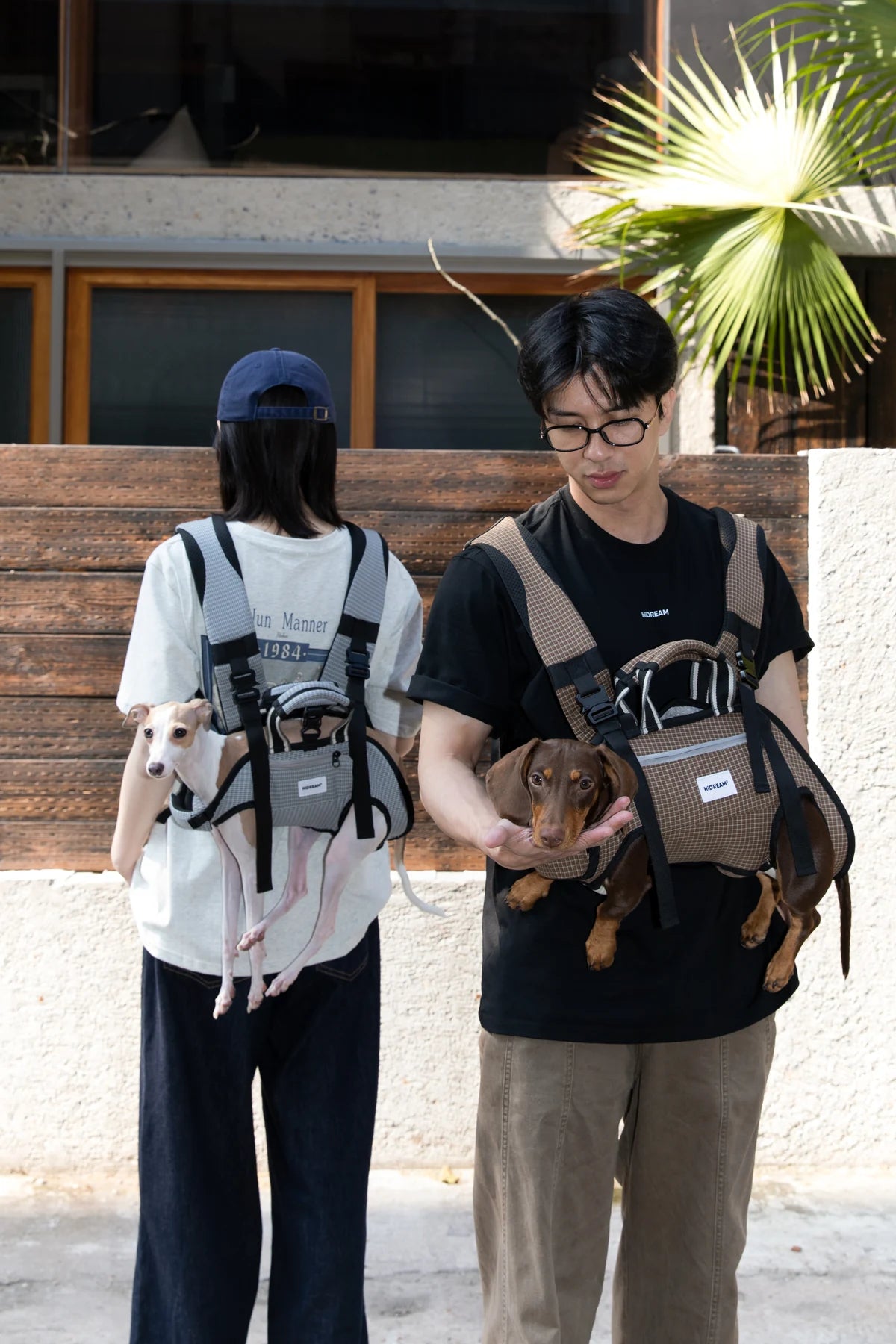 Two owners demonstrating Gray and Brown Check carriers outdoors; each carrier sold separately